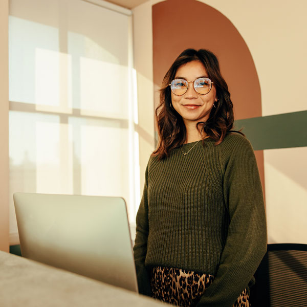 woman standing in front of computer